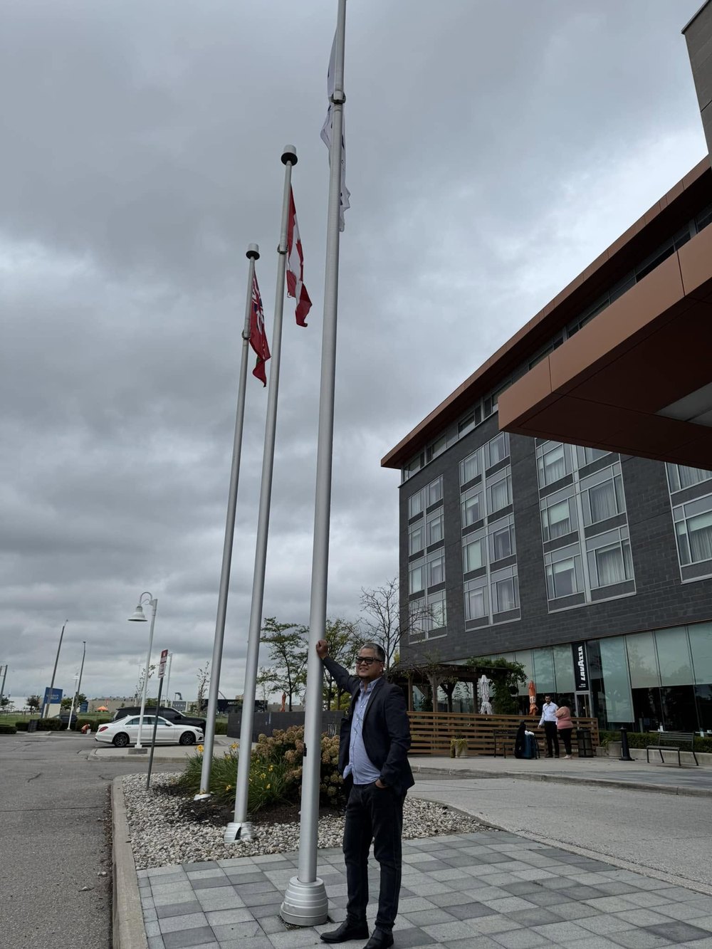 Rovic Cruz beside flagpoles during international travel